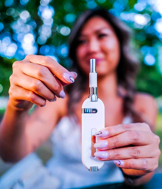 Woman holding weed vape cart outside