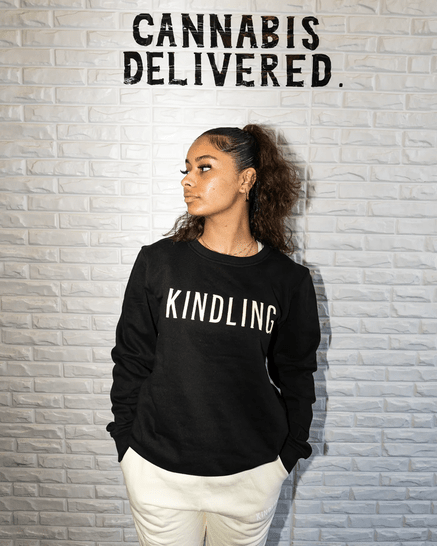 Woman wearing black Kindling crew neck sweatshirt